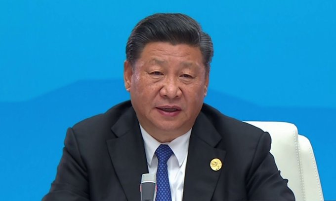 A portrait of Chinese President Xi Jinping against a blue background, illustrating an article regarding the pressure on China's $651B in U.S. Treasury holdings.