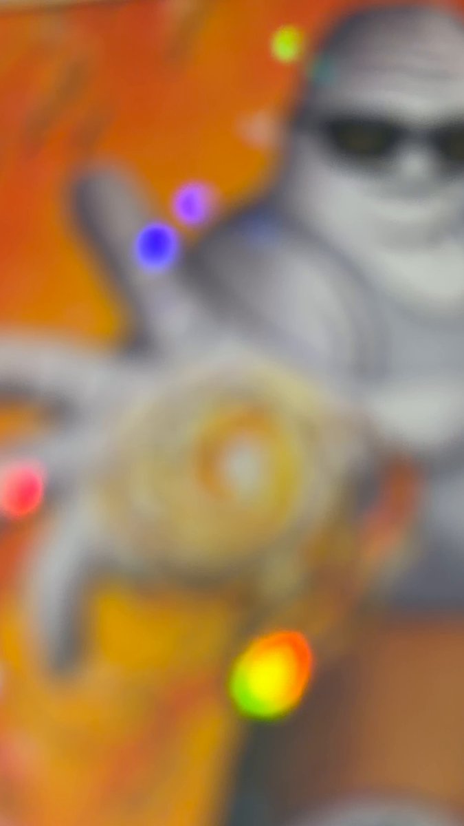 The image features an orange background with a white figure wearing sunglasses, holding up a hand with a ring or bracelet on their finger. The text in the caption reads "I think now is a good time to pull these bad boys out. @OfficialUncX & @blknoiz06 I choose you! PSA told me they're 10'10" without a shadow of a doubt."