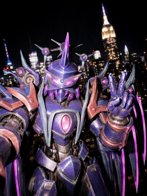 A purple and silver armored robotic figure with a spiked helmet poses in front of the New York City skyline at night, holding up its hand.