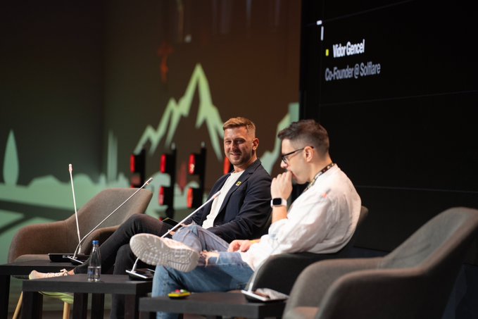 At the Solana Summit Serbia, Solflare co-founder Victor Gancel (as shown on screen) sits on stage alongside another speaker, engaging in a panel discussion about the future of tokenized assets and decentralized markets.