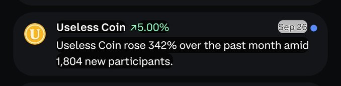 A notification card on a dark background shows that 'Useless Coin' has risen 5.00% as of Sep 26, noting that it 'rose 342% over the past month amid 1,804 new participants.'