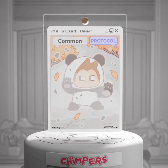 A trading card displayed on a stand features a character in a bear suit titled 'The Quiet Bear', labeled as 'Common' and 'PROTOCOL', with 'CHIMPERS' written on the stand's base.