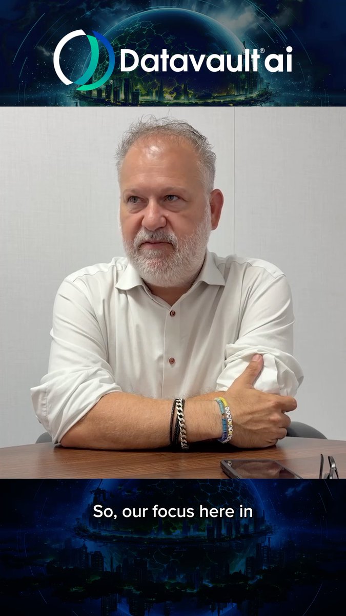 A portrait of a gray-bearded man in a white button-down shirt sitting at a wooden table beneath a "Datavault ai" logo header, with a caption beginning "So, our focus here in" at the bottom.