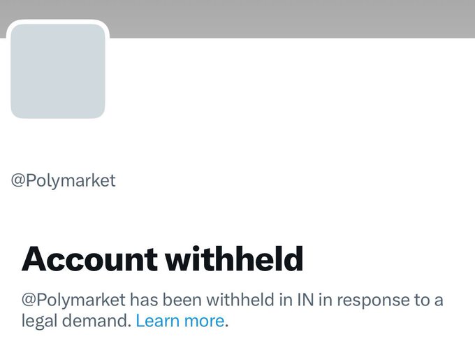 The image shows a Polymarket notice reading “Account withheld” and stating, “@Polymarket has been withheld in IN in response to a legal demand. Learn more.” This blocking in India relates to the post’s claim that it is “worse than 9/11 for Indian polymarket farmers,” who may be unable to access or cash out positions.