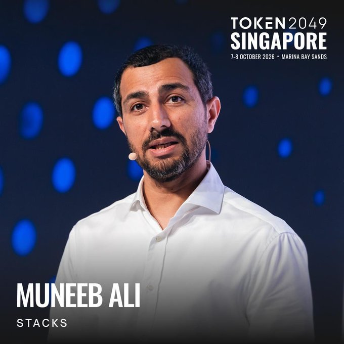 Promotional graphic for TOKEN 2049 Singapore (7-8 October 2026, Marina Bay Sands) featuring Muneeb Ali of Stacks.