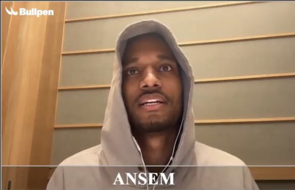 A man named Ansem is shown wearing a gray hoodie with the hood pulled up, speaking directly to the camera in what appears to be a video interview or recording, with "ANSEM" displayed at the bottom of the frame and the "Bullpen" logo in the top corner. The image relates to the post's suggestion that the person bears a resemblance to a character from the Bulltoshi NFT project.