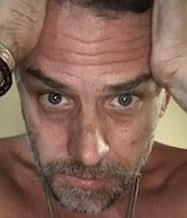 A close-up photo of a distressed-looking man clutching his head in apparent anguish, visually representing the dramatic decline implied by the accompanying post about "Hunter Biden's $LAPTOP" dropping 50% amid significant wallet accumulation. The image, which appears to be a meme, captures a meme-stock-style panic reaction to the cryptocurrency's plummeting value.