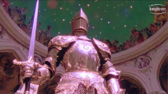 A towering knight in ornate silver armor holds a sword aloft beneath a starry green ceiling in a grand, frescoed hall. The "knightcore" watermark in the corner and the caption "Witness $KNIGHT" frame the scene as a heroic, larger-than-life embodiment of the knight archetype.