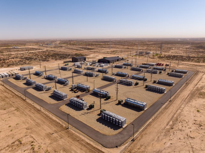 This aerial view showcases the Salt Creek facility in Orla, Texas, where numerous containers are arranged in rows, representing a large-scale Bitcoin mining operation. The site's expansive layout and the abundance of these containers visually confirm the claim of Bitcoin mining running at scale in West Texas.