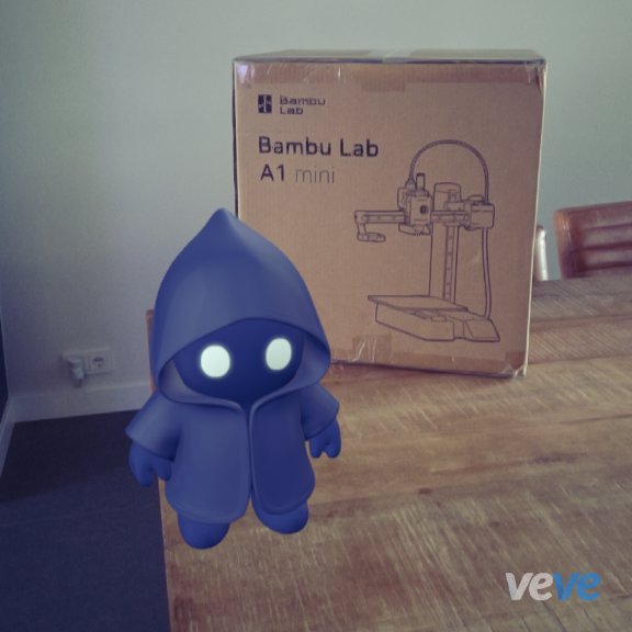 A blue hooded character figure with glowing eyes stands in front of a Bambu Lab A1 mini 3D printer box, suggesting the figure was likely 3D printed as the creator's first project with their new printer. The "veve" watermark in the corner indicates the character is from the VeVe digital collectibles platform, tying into the post's mention of @veve_official and the excitement of building a new collectibles squad.