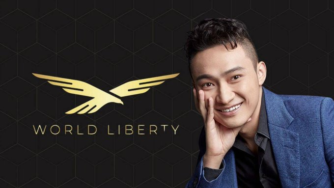 Justin Sun smiles warmly beside the gold "WORLD LIBERTY" eagle logo, visually representing the ongoing legal battle between the crypto entrepreneur and World Liberty Financial (WLFI) as a federal court allows his personal claims to remain in public proceedings.