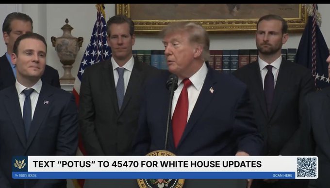 President Trump speaks at a podium in front of other men, with a banner below reading "TEXT 'POTUS' TO 45470 FOR WHITE HOUSE UPDATES." This image likely depicts the context of his statement about ending the "war on crypto."