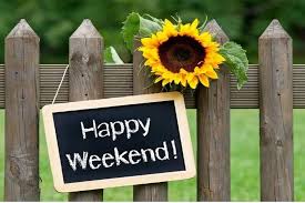A wooden picket fence with a sunflower and a chalkboard-style sign that reads 'Happy Weekend!'