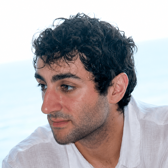 A close-up profile photo of a dark-haired man with a prominent nose, wearing a white shirt against a bright, hazy background. The image accompanies a post criticizing someone on the FOMO app, with the caption using the man's side profile to mock his nose as an indicator of him being a "jeet" who scams copy traders.