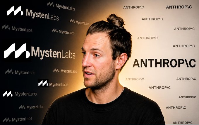 A man with his hair in a topknot speaks in front of a backdrop split between "Mysten Labs" on the left and "ANTHROPIC" on the right.