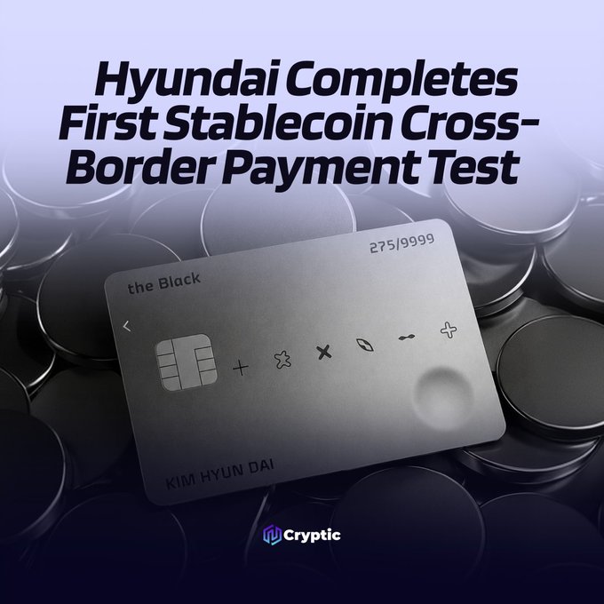 A silver Hyundai "the Black" card numbered 275/9999 belonging to KIM HYUN DAI rests on dark circular tokens, overlaid with the headline "Hyundai Completes First Stablecoin Cross-Border Payment Test" and the Cryptic logo, visually representing Hyundai Card's pioneering stablecoin-based transaction between its U.S. and Mexico subsidiaries.