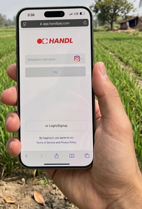 A hand holds a smartphone displaying the HANDL app (app.handlpay.com) login screen with an Instagram username field, set against a background of a green field.