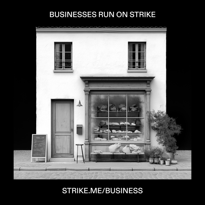 A black-and-white image shows a quaint bakery storefront with bread loaves displayed in the window, captioned "BUSINESSES RUN ON STRIKE" at the top and "STRIKE.ME/BUSINESS" at the bottom. The image illustrates the post's mention of onboarding a bakery as one of several new businesses using Strike's reduced-fee bitcoin trading platform.