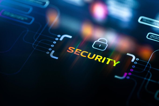 The image shows a close-up view of a computer screen displaying the word "security" written in white letters against a dark blue background. The text appears to be floating or shimmering due to the lighting, giving the impression that it's glowing. The image also contains some lines and dots on the screen, which could potentially represent data or other elements related to the vulnerability being discussed.