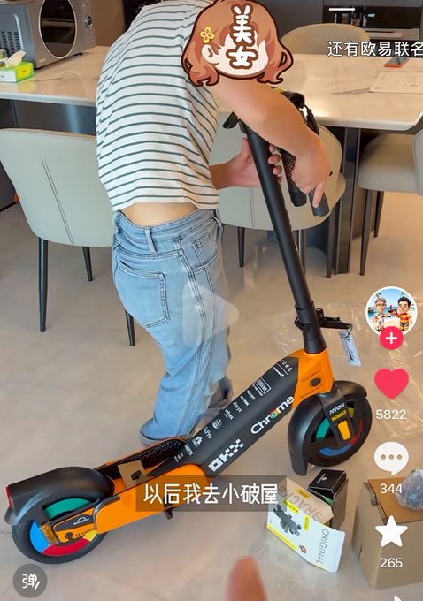 A short video screenshot of a person in jeans standing on an electric scooter branded with 'OKX' and 'Chrome' logos, with Chinese text overlay reading '以后我去小破屋' and '还有欧易联名'.