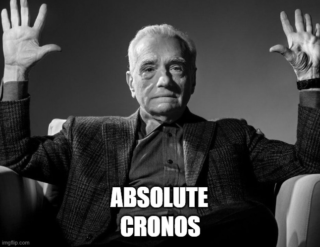 A black and white photo of an elderly man with his hands raised in a shrugging gesture, with the text 'ABSOLUTE CRONOS' overlaid in white.