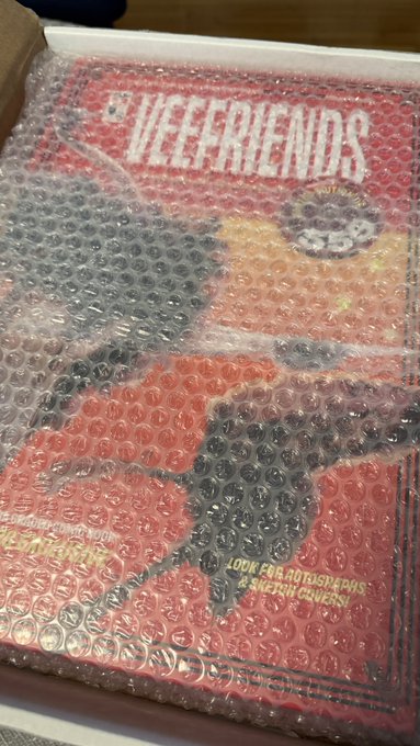 A package wrapped in bubble wrap featuring a 'VEEFRIENDS' design with a cartoon character and the text 'LOOK FOR ADVERSARIES & RATION CHAOS!'