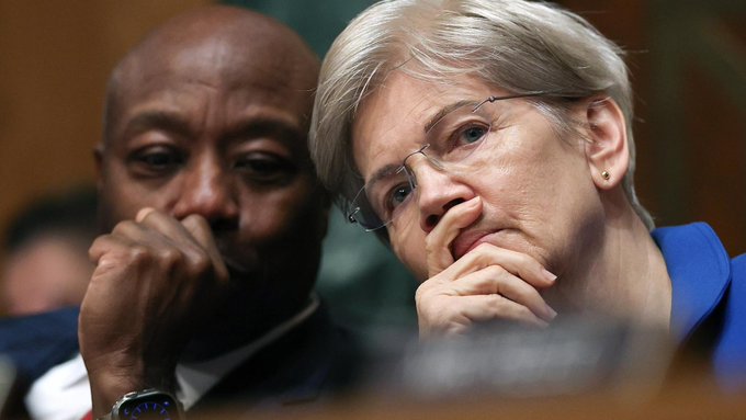 Senator Elizabeth Warren (D-MA) and a colleague appear deep in thought during a tense Senate session, reflecting the high-stakes nature of the upcoming CLARITY Act vote where Democrats must decide whether to break ranks and provide the seven votes needed to advance the crypto market structure bill.