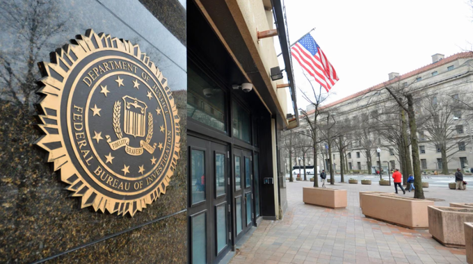 A split image displays the Federal Bureau of Investigation seal on a stone wall beside the entrance of a building with an American flag, with a pedestrian plaza visible in the background.