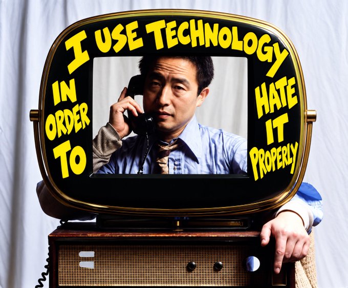 A vintage television set framing a man on a rotary phone, with bold yellow text overlaid around the screen reading 'I USE TECHNOLOGY IN ORDER TO HATE IT PROPERLY'.