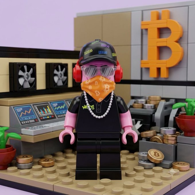 A Lego minifigure wearing a cap with "NFTP" branding, red headphones, an orange Bitcoin-patterned face covering, and a pearl necklace stands in front of a crypto trading setup featuring screens with charts, a large orange Bitcoin logo, and scattered BTC coins, fitting the "gm nfts" crypto greeting.