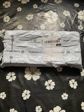A sealed Cooler Master accessory package rests on a black floral-patterned surface, likely containing a new keyboard as celebrated in the community post congratulating the recipient on their new typing gear.