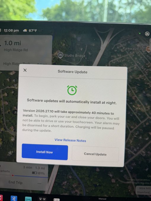 A Tesla touchscreen displays a Software Update notification for Version 2026.27.10, which will take approximately 40 minutes to install, with options to 'Install Now' or 'Cancel Update'.