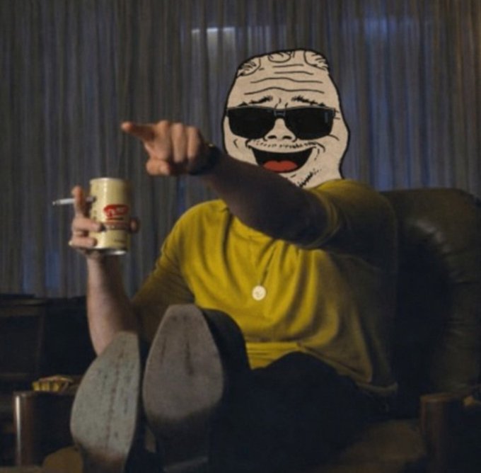 A person wearing a yellow shirt and an oversized cartoon-like smiling face mask points forward while holding a can of beer and a cigarette, with their feet propped up in the foreground.