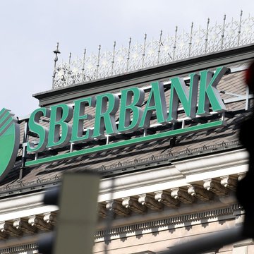 A photograph showing the green "SBERBANK" signage on the exterior of a building.