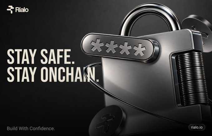 A dark promotional graphic for "Rialo" featuring a large metallic padlock with asterisks for a password, displaying the text "STAY SAFE. STAY ONCHAIN." and "Build With Confidence." along with the URL rialo.io.
