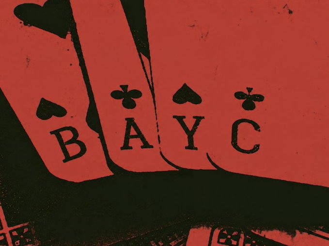 The image is a stylized, high-contrast red-and-black photograph of playing cards held in a fan shape, with the letters "B A Y C" styled like card indices.