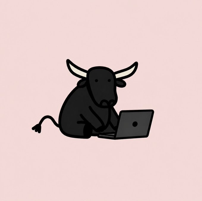 A minimalist cartoon illustration of a black bull with white horns sitting and typing on a gray laptop against a pale pink background.