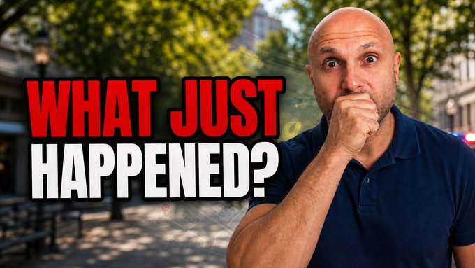A bald man in a navy polo shirt covers his mouth with a shocked expression, overlaid with large red and white text reading "WHAT JUST HAPPENED?" against a blurred outdoor background.
