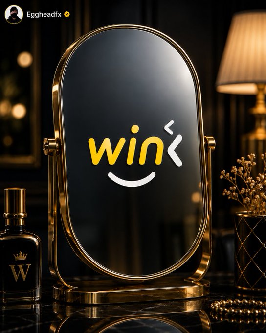 Gold-and-black mirror displaying the yellow-and-white “win” logo, branded by “Eggheadfx,” in a luxury setting with perfume, a lamp, and decorative objects.