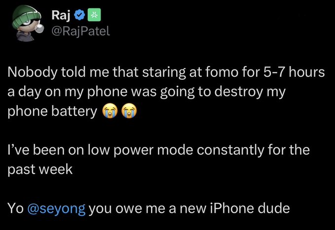 A screenshot of a tweet by Raj (@RajPatel) complaining that staring at 'fomo' for 5-7 hours daily has drained his phone battery, tagging @seyong and joking that he owes him a new iPhone.