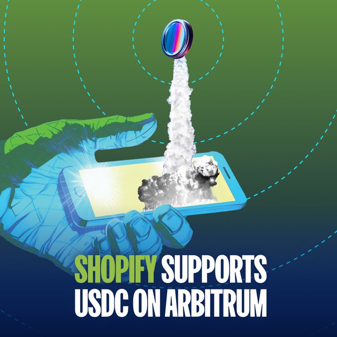 The image shows an illustrated blue and green hand holding a smartphone, with a rocket—adorned with a USDC logo—launching from its screen amid clouds of smoke, set against a green and blue background with dashed orbital lines. The text reads "SHOPIFY SUPPORTS USDC ON ARBITRUM," visually echoing the post's announcement of USDC stablecoin payments now being integrated into Shopify's checkout system via the Arbitrum network.
