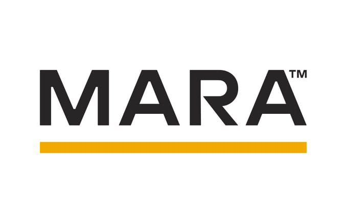 The image displays the MARA logo, featuring bold black uppercase letters with a trademark (™) symbol and an orange underline beneath the text. This logo represents MARA Holdings, the publicly traded Bitcoin mining company referenced in the post about its significant BTC sales in the first half of 2026.