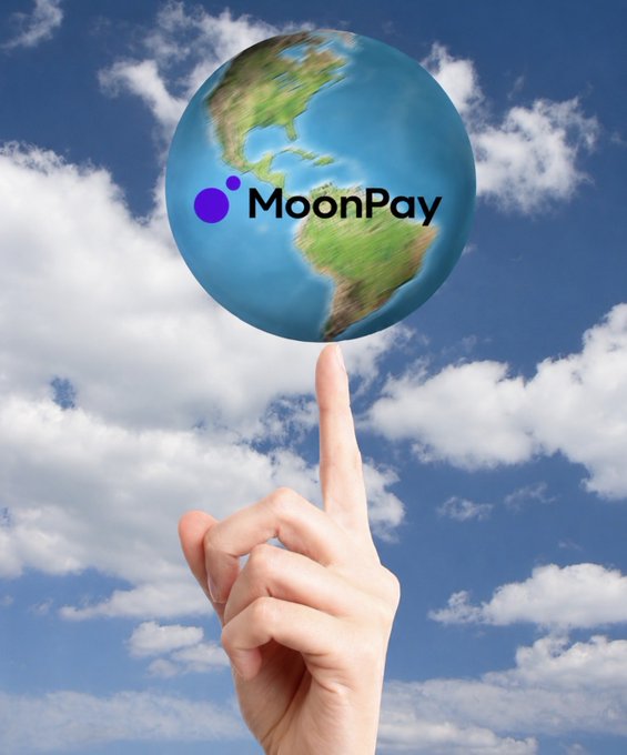 A hand pointing up at a globe of the Earth floating against a cloudy blue sky, with the "MoonPay" logo and name overlaid on the globe, visually representing the company's global reach as it "moves the world."