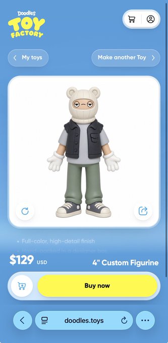 A mobile app screen from Doodles Toy Factory displaying a 4-inch custom figurine priced at $129 USD, showing a character wearing a bear hood, glasses, and a gray vest with green pants.