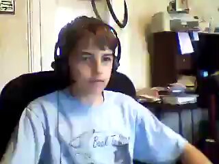 The image shows a young boy wearing headphones, sitting at a desk with books surrounding him. In his hand, he holds a computer mouse. On the computer monitor next to him, there's text that reads, "A 12-year-old was explaining Bitcoin in 2001 when it was $5." The main focus of this image is the young boy and his interaction with technology.