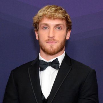 Logan Paul, a curly-haired YouTuber in a black tuxedo and bow tie, is pictured smiling in a posed portrait. The image accompanies a post about his profitable NFT investment, which has appreciated significantly from $635,000 in 2021 to $5.43 million today.