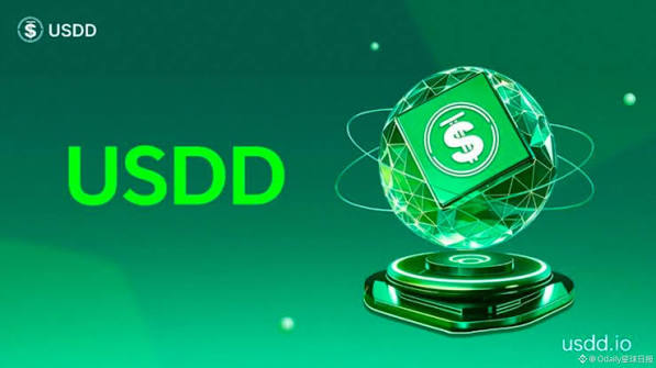 A promotional graphic for USDD cryptocurrency features the bold green text "USDD" alongside a futuristic, glowing green polyhedral emblem displaying a dollar sign symbol, with the website "usdd.io" and "Oddity区块链" branding in the corners. The image visually reinforces the post's message about exploring USDD ($USDD) as users embark on the Travala Summer Escape journey to learn how crypto assets bridge digital wallets and real-world travel experiences.