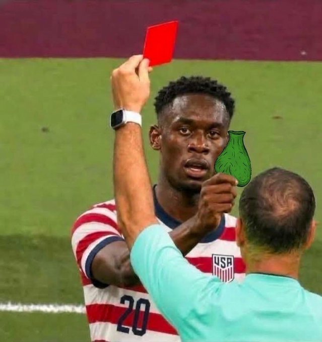 A soccer player in a USA #20 jersey receiving a red card from a referee, with a 'Jadeja crying' meme face edited over the referee's face.