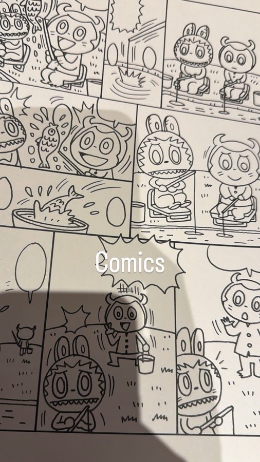A sketchbook page showing hand-drawn comic panels featuring cute characters fishing and playing, labeled 'Comics'.