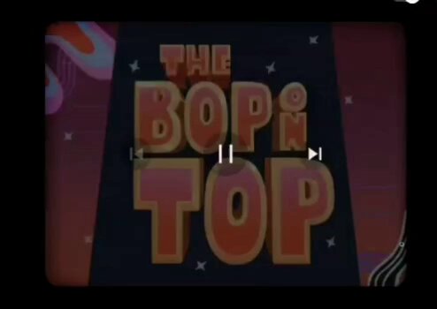 The image features a retro-style television screen with the words "The Bop 'n Top" displayed prominently at the top, along with an illustration of a person wearing a suit and tie. The background of the image has a pinkish hue, giving it a vintage appearance. The text on the screen is in a larger font size than the rest of the image, making it stand out more.